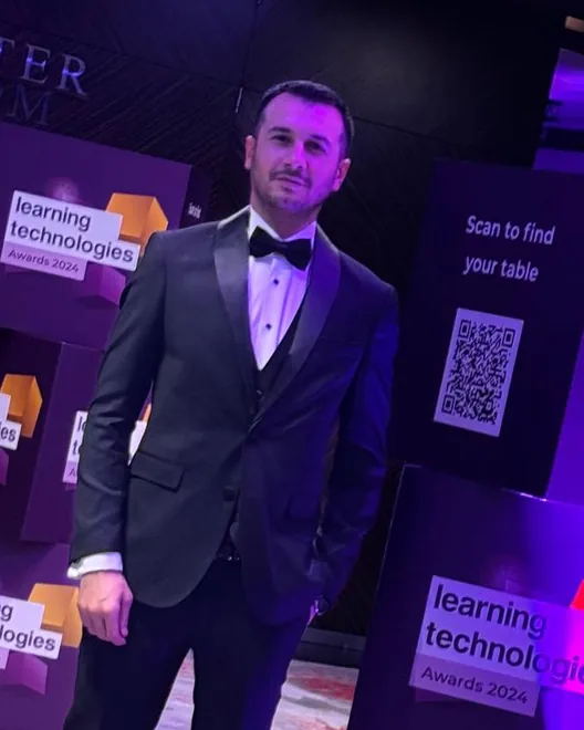Sinan in a tuxedo at the Learning Technologies Awards 2024 ceremony in London