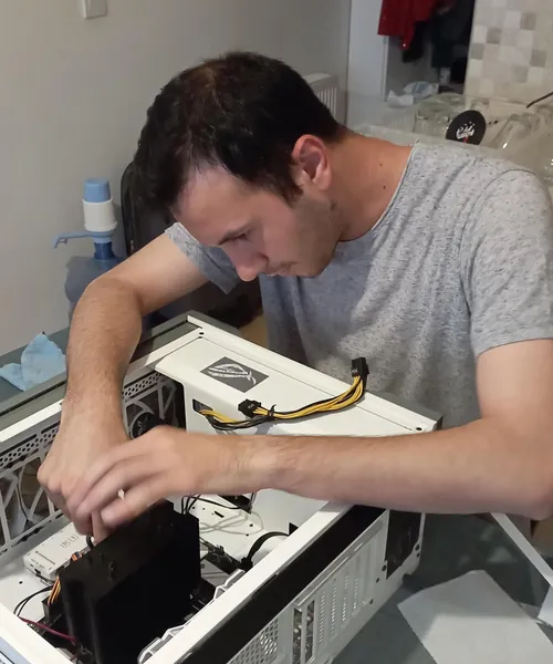 Sinan building a PC, installing a CPU cooler in an open case